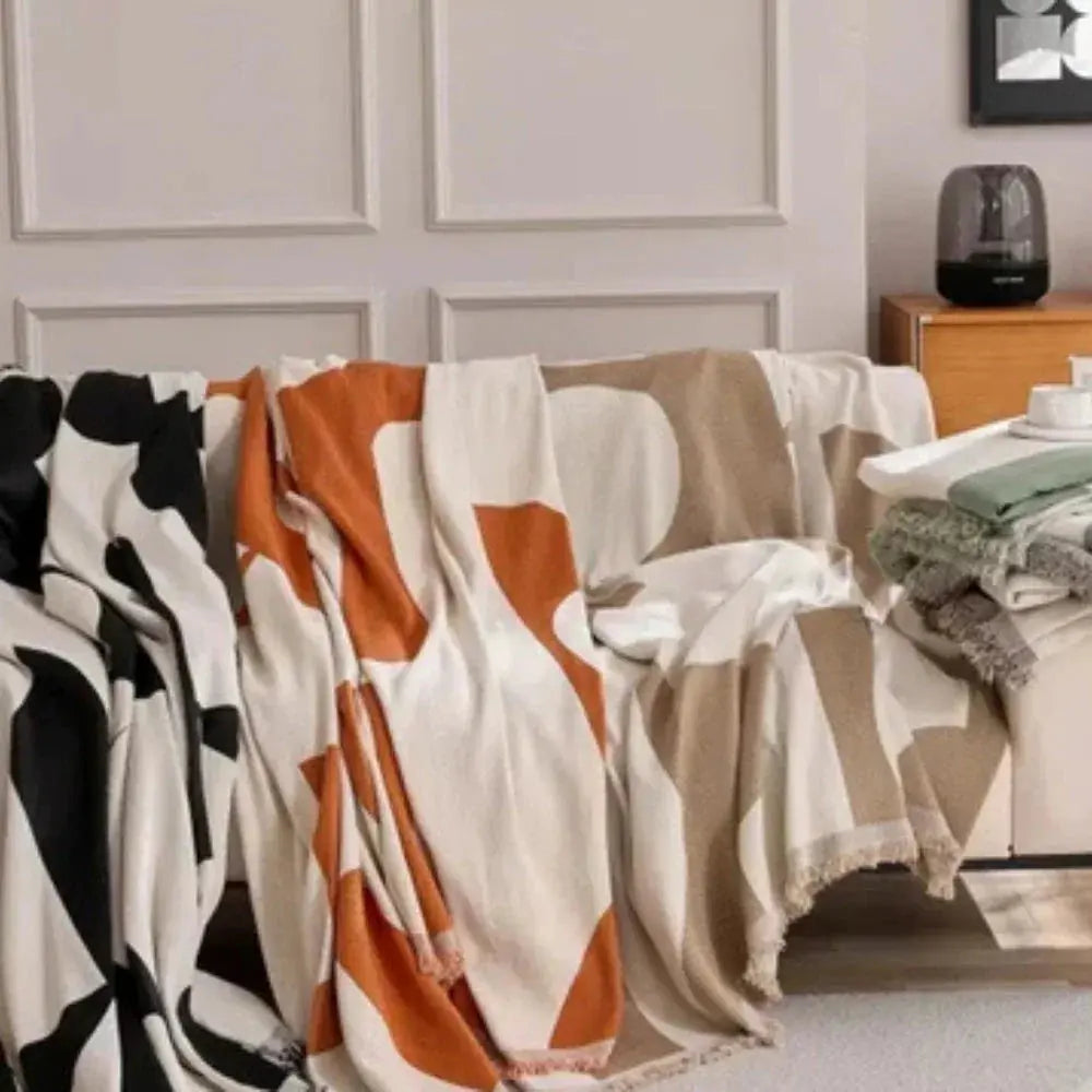 Geometric chenille throws in black, orange and beige