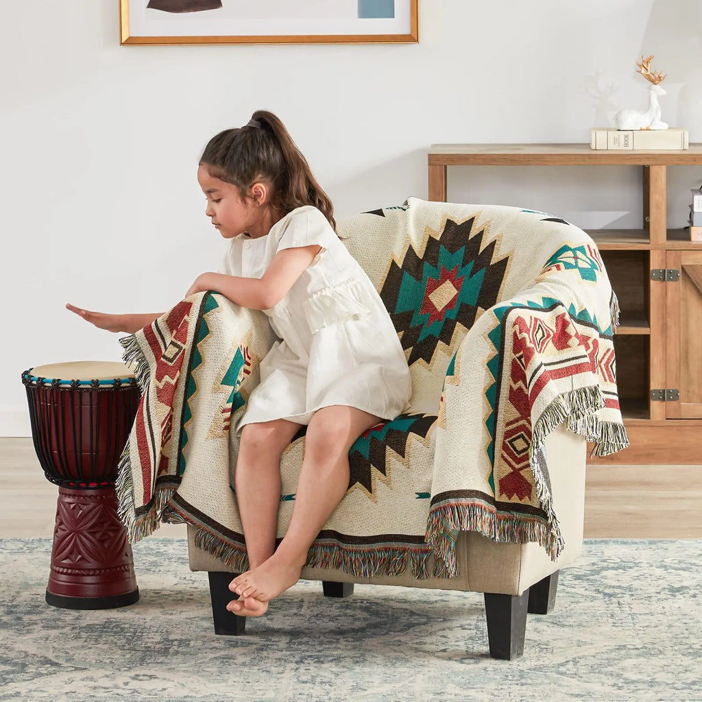 Girl sitting on chair with Aztec throw blanket