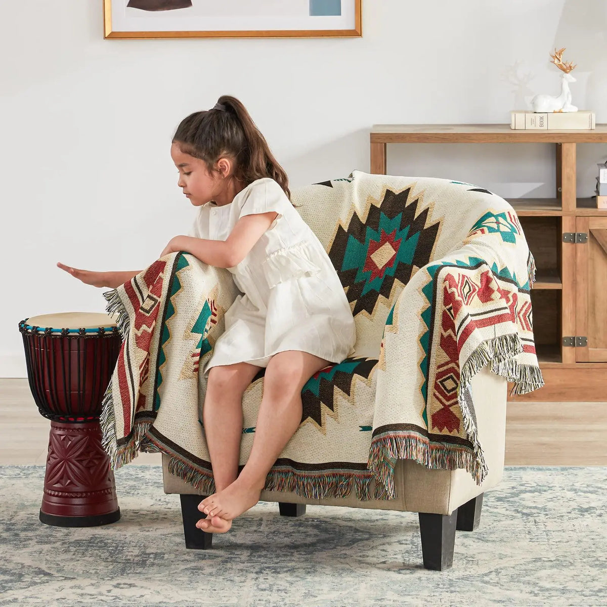 Girl sitting on chair with Aztec throw blanket