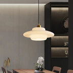 Glass pendant light over dining table