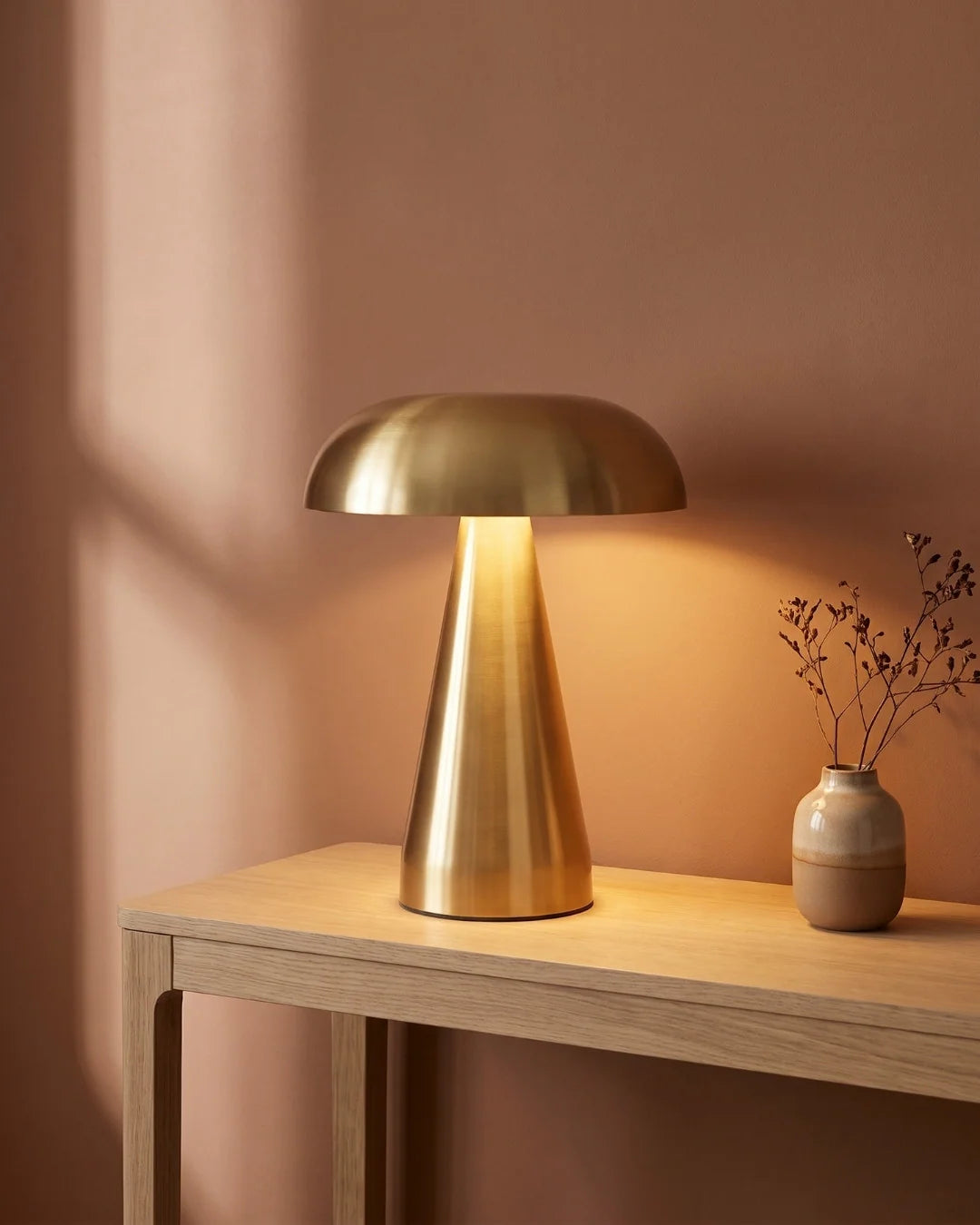 Gold cordless lamp on console table
