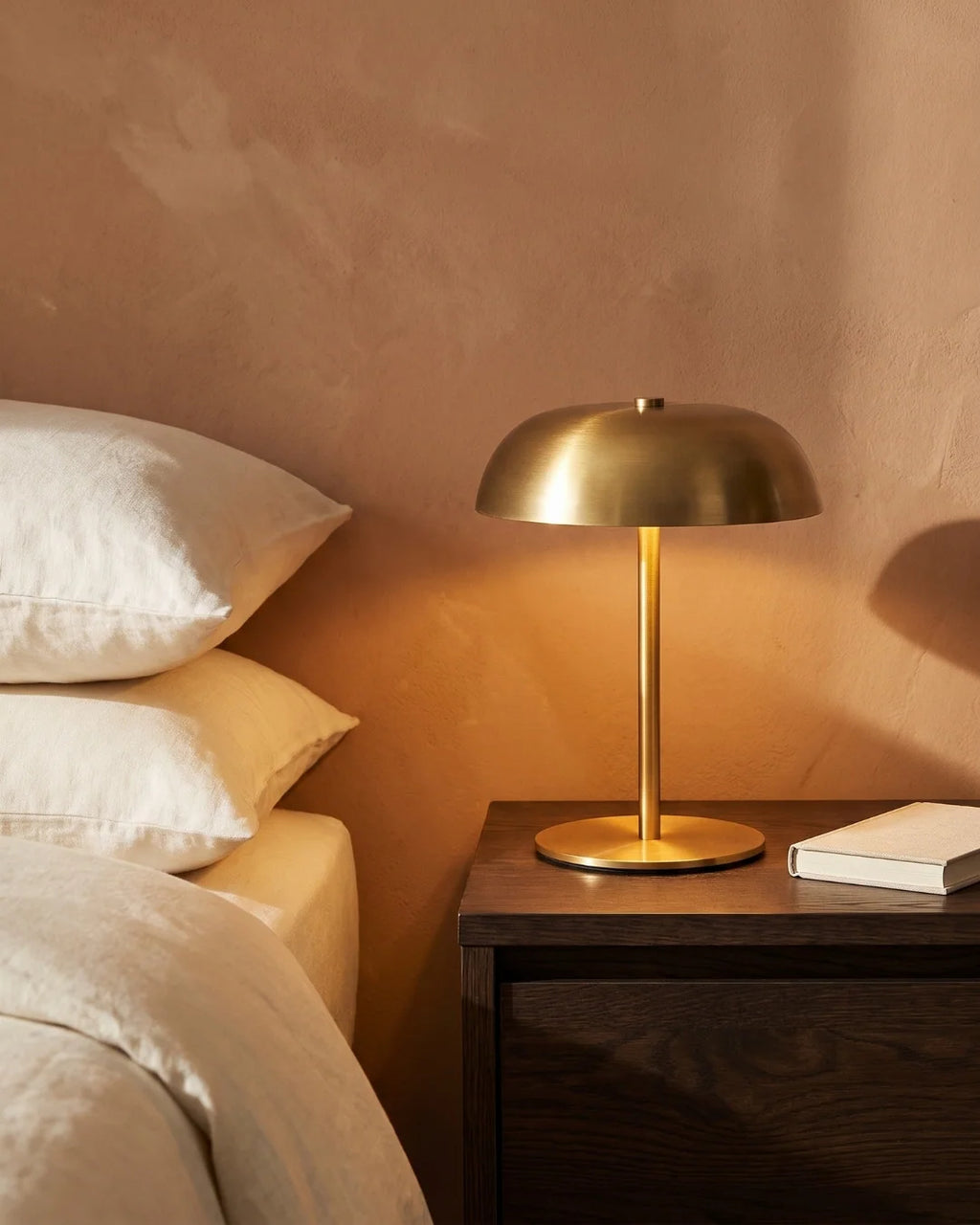 Gold cordless lamp on nightstand