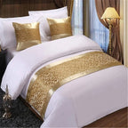 Gold jacquard bed runner on hotel-style bed
