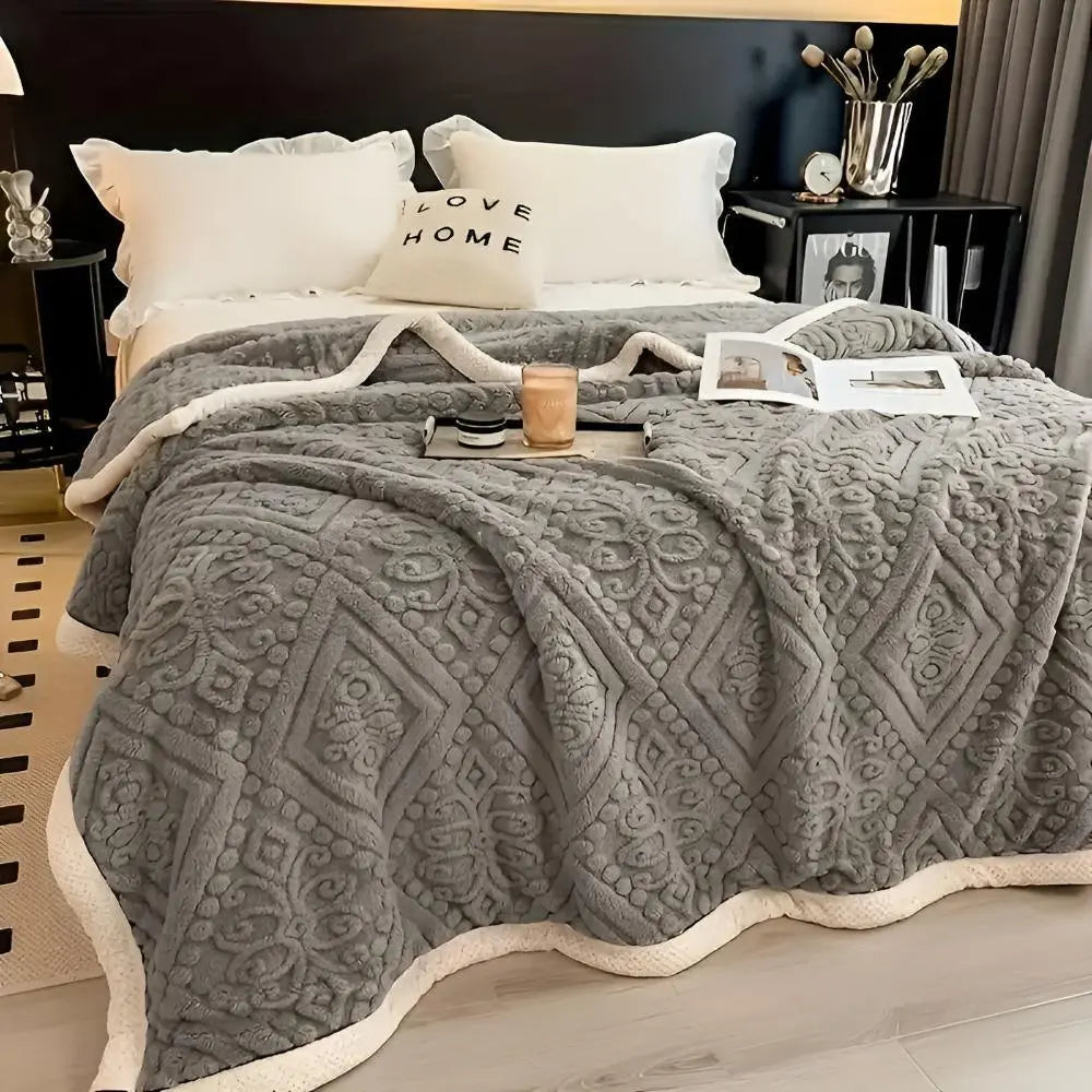Gray embossed fleece blanket on bed