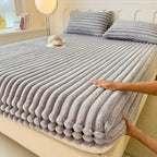 Gray faux fur fitted sheet on bed