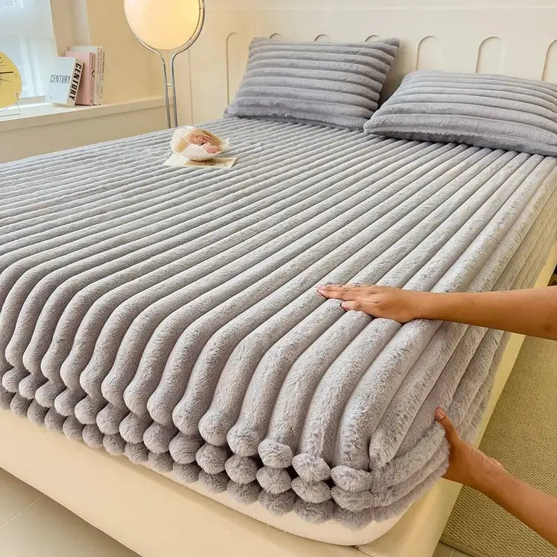 Gray faux fur fitted sheet on bed