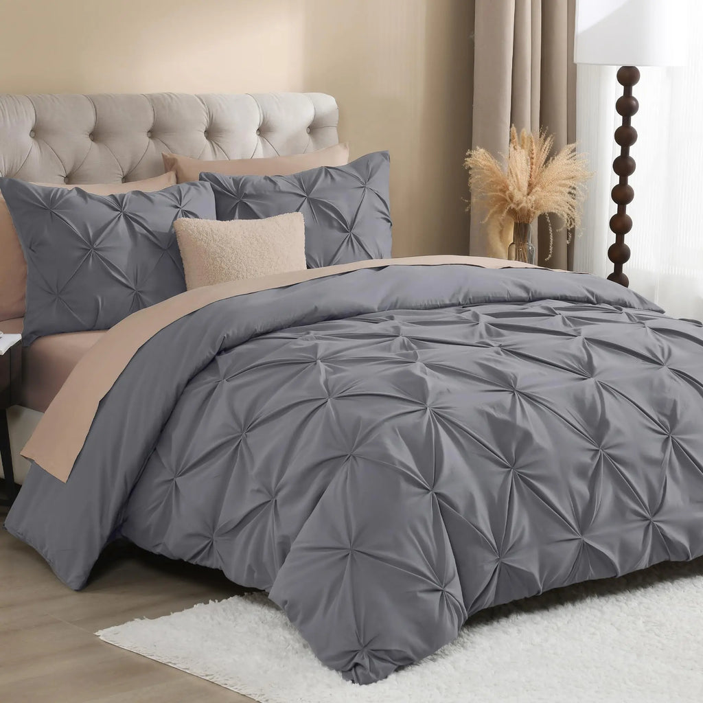 Gray pinch pleat bedding with blush accents
