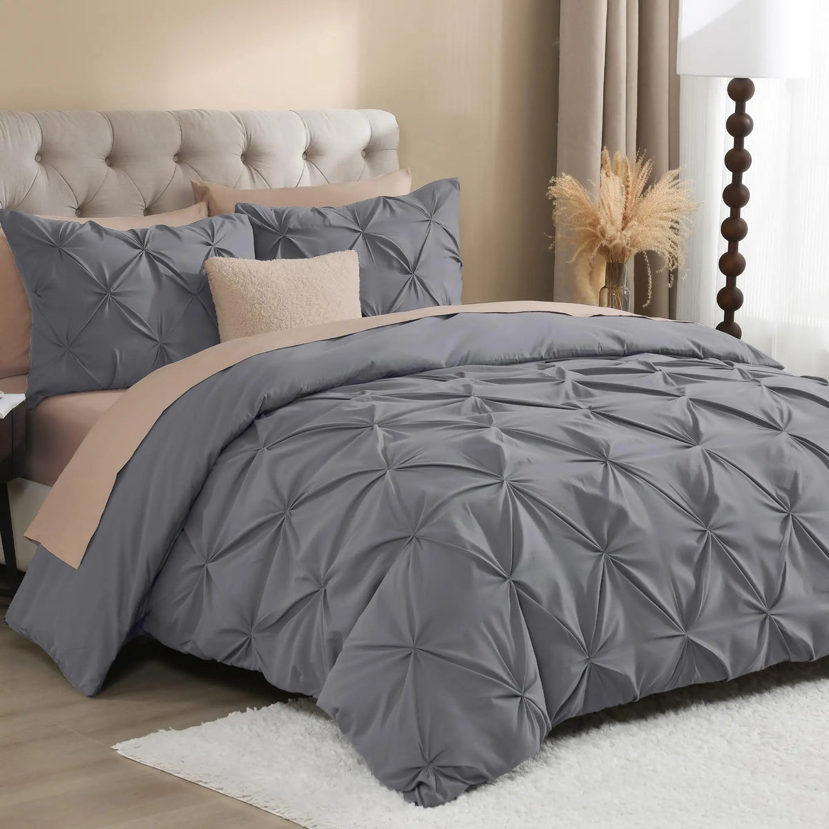 Gray pinch pleat bedding with blush accents
