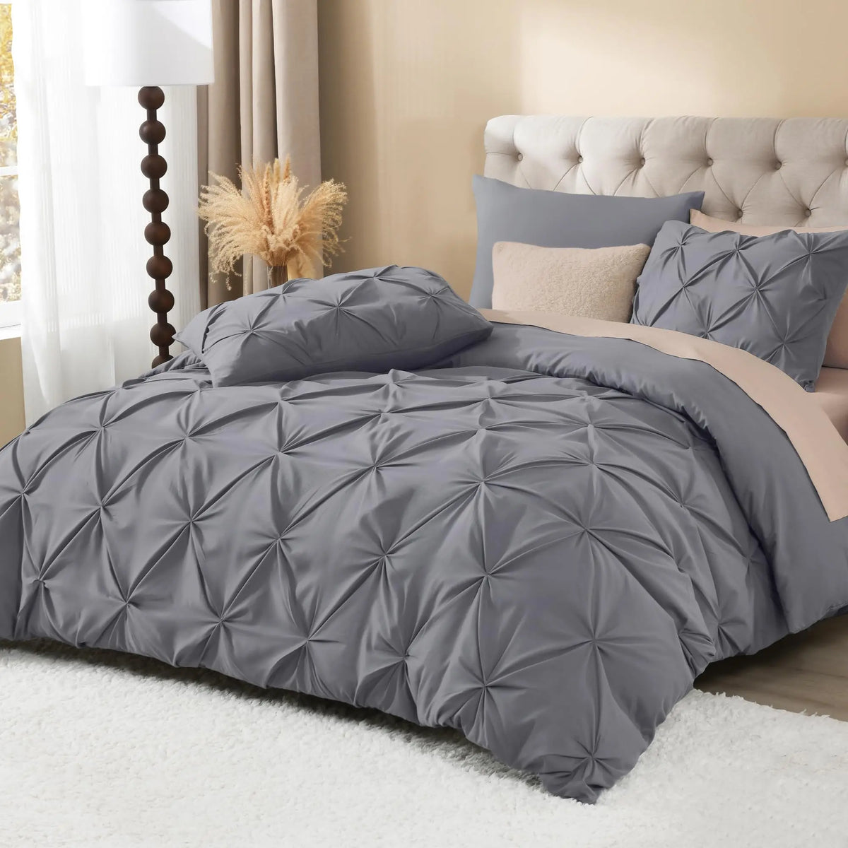 Gray pinch pleat duvet cover set on bed