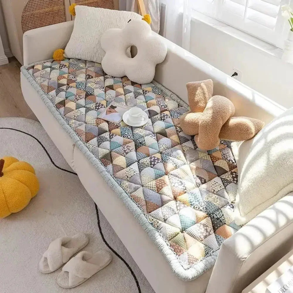 Gray quilted pet sofa cover on couch