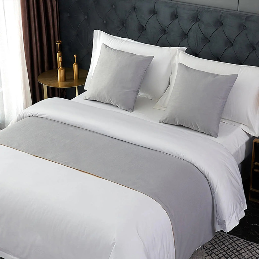 Gray velvet bed runner on bed