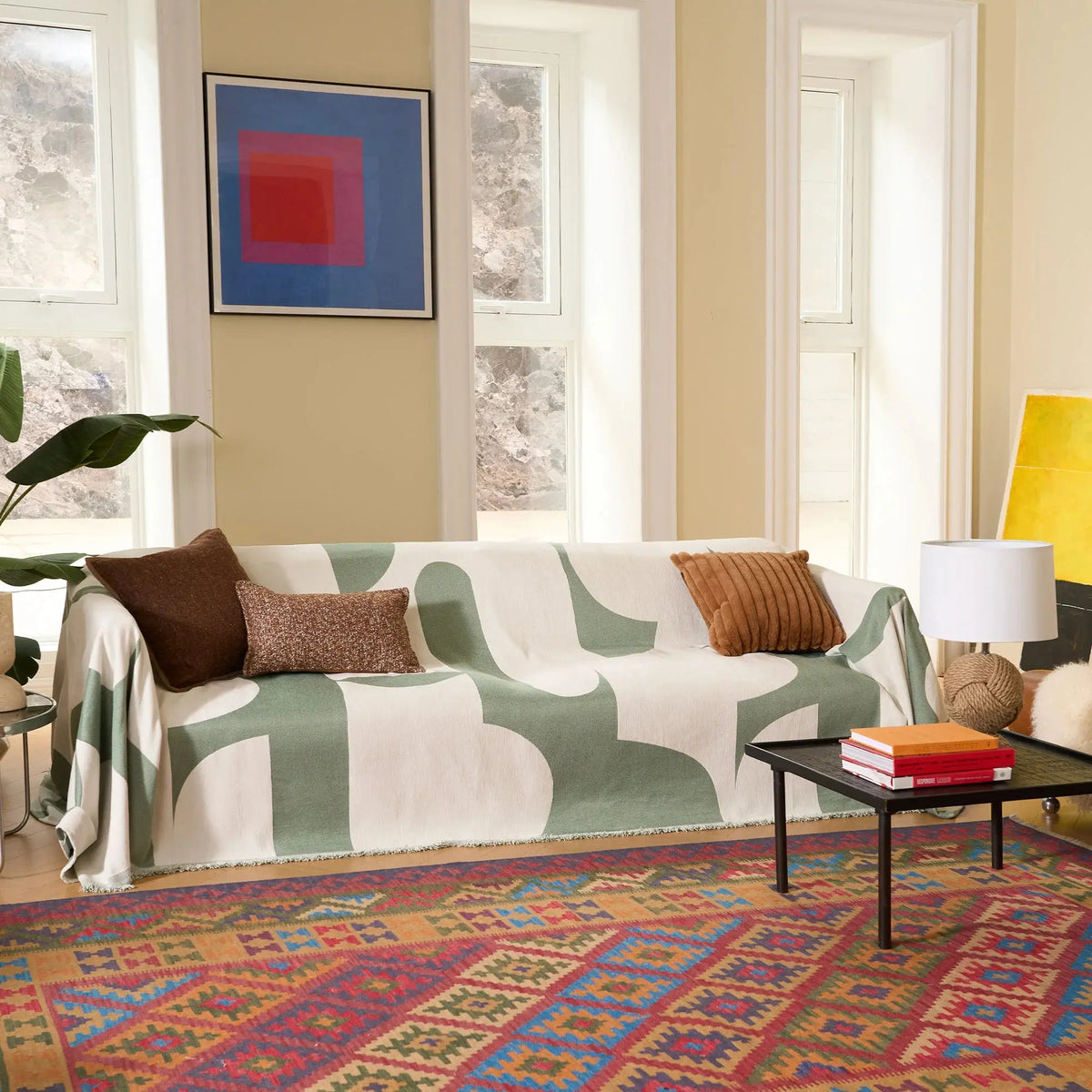 Green geometric couch cover in mid-century living room