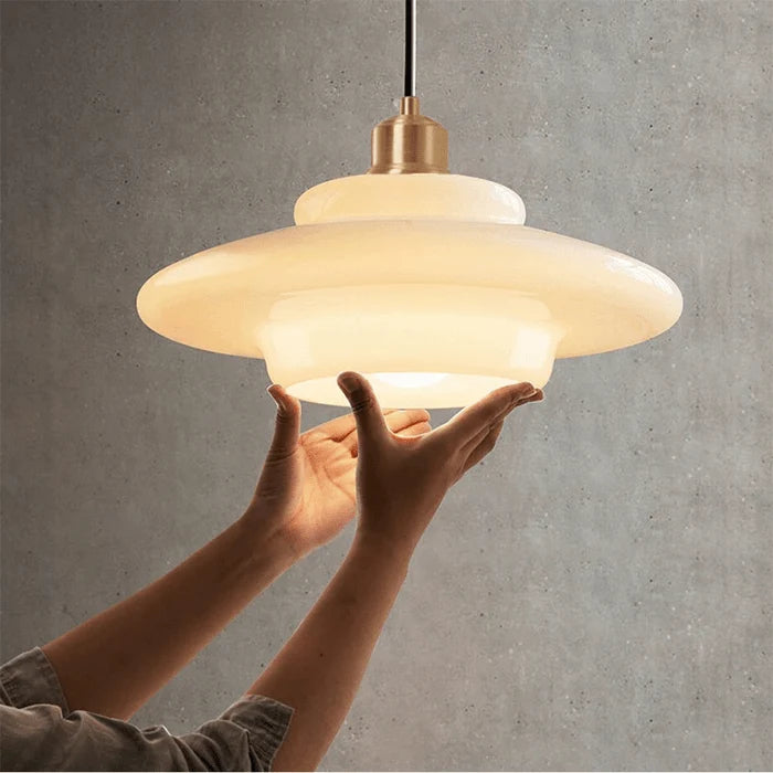 Hand holding milk glass pendant light