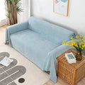 Light blue waterproof couch cover draped over sofa