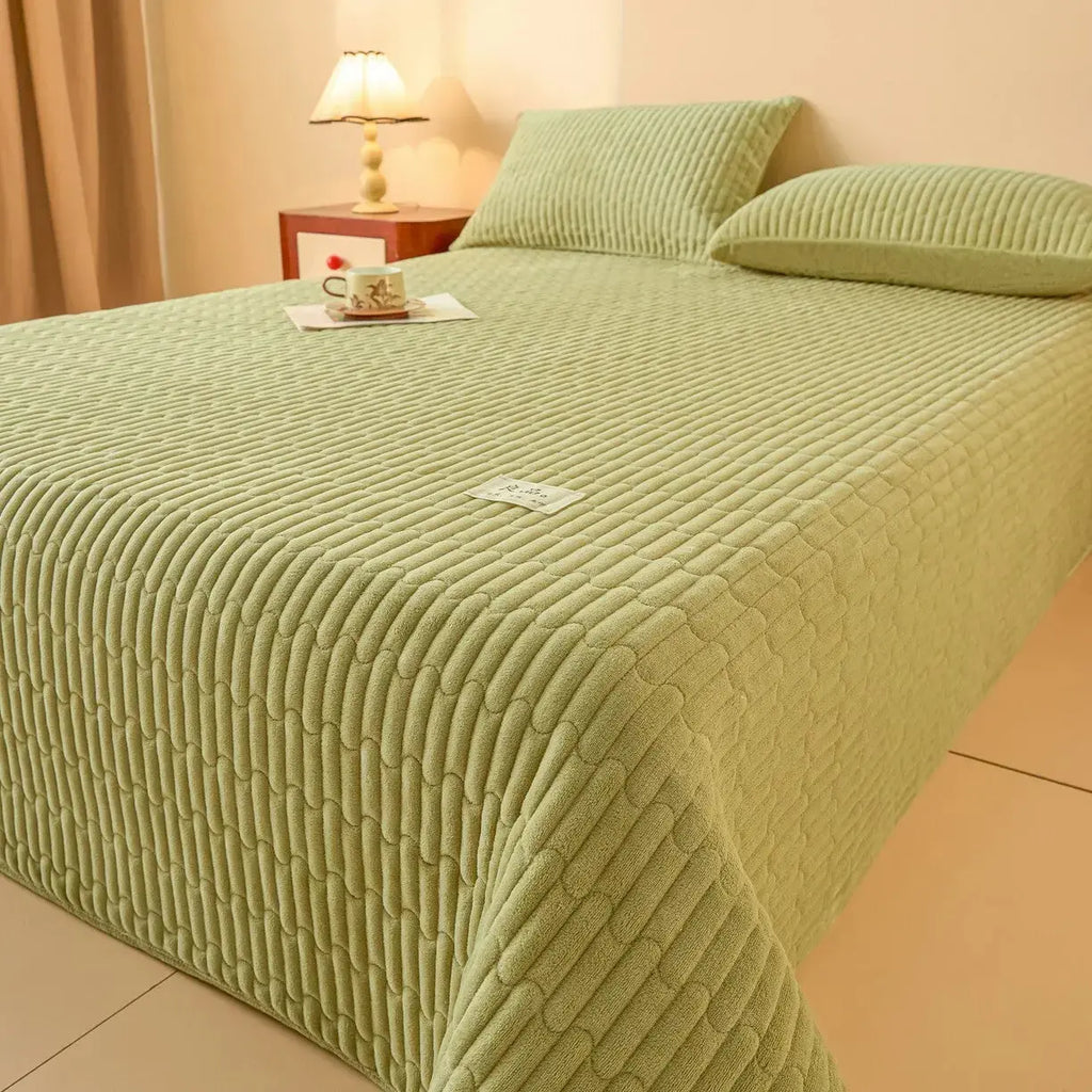 Mint green quilted coverlet set on bed