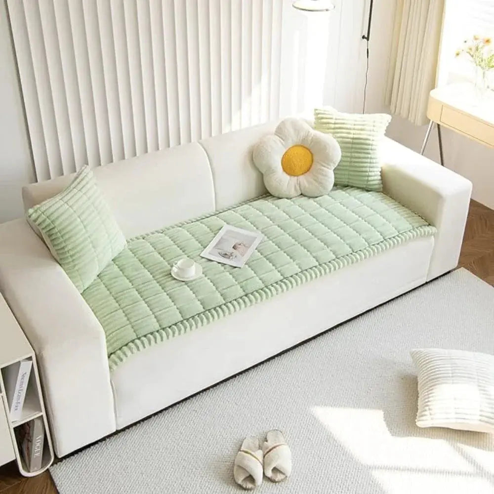 Mint plush couch cover on sofa in bright room