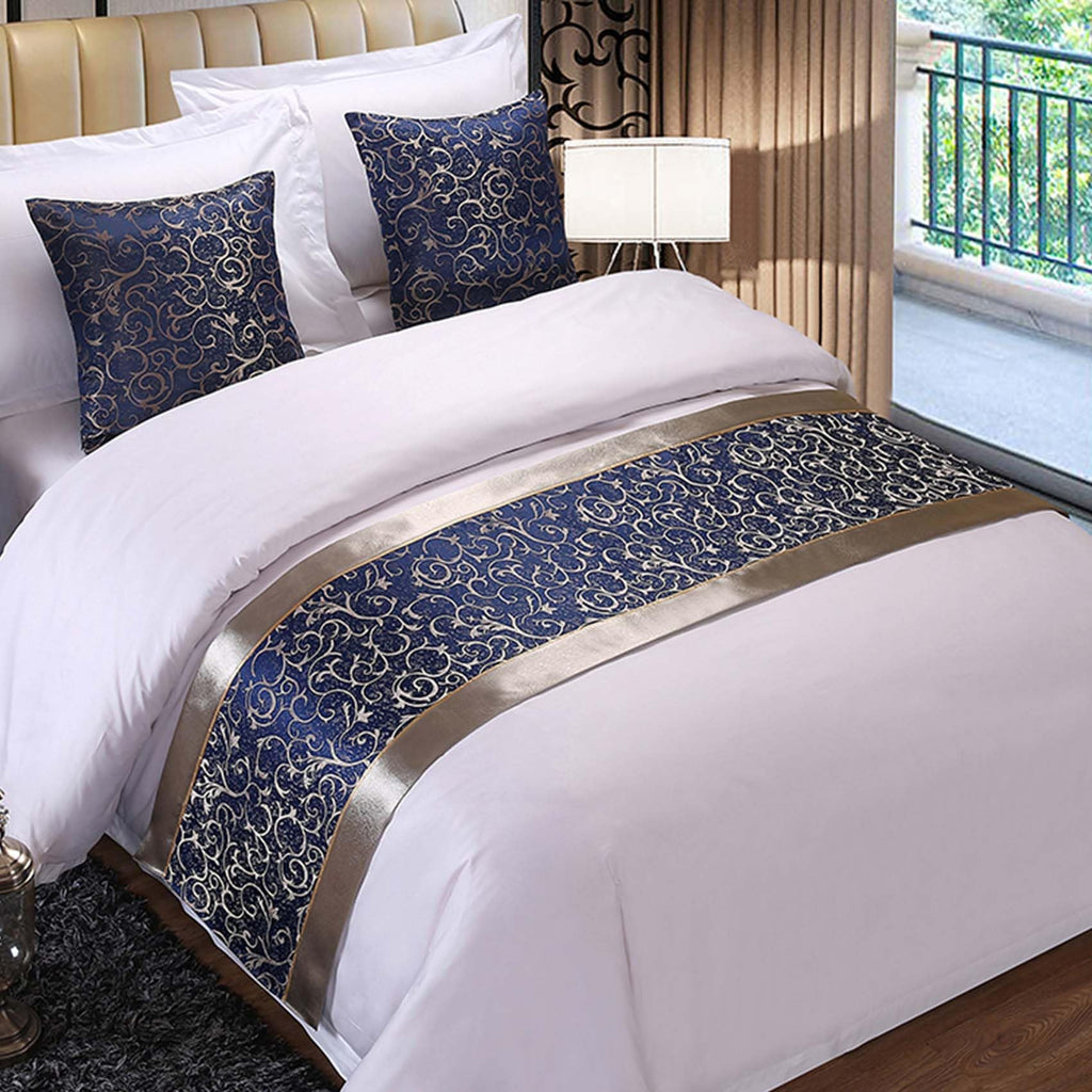 Navy and gold jacquard bed runner on white bed