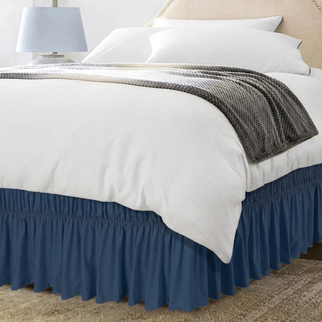 Navy blue ruffled bed skirt on bed