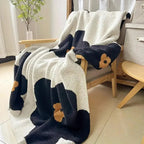 Navy floral throw blanket on armchair