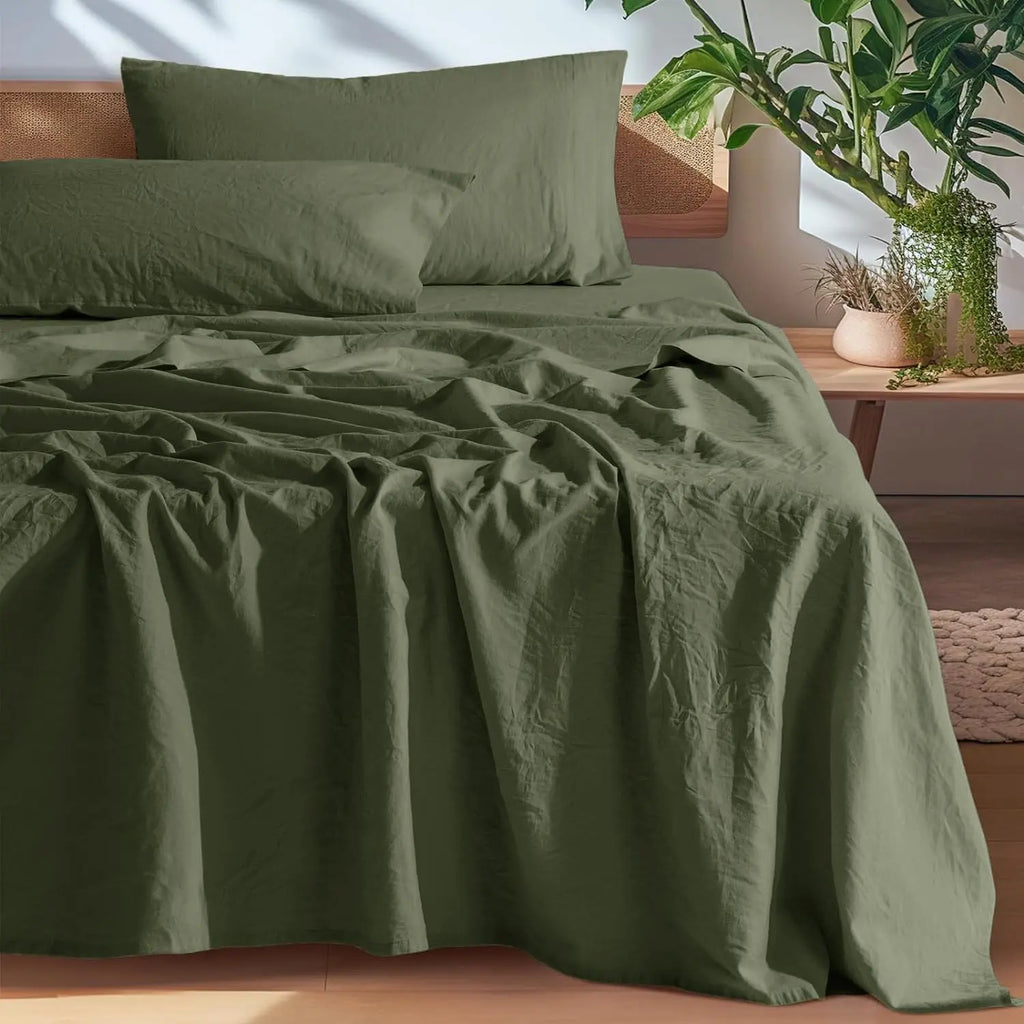 Olive green linen sheet set on bed