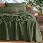 Olive green linen sheet set on bed
