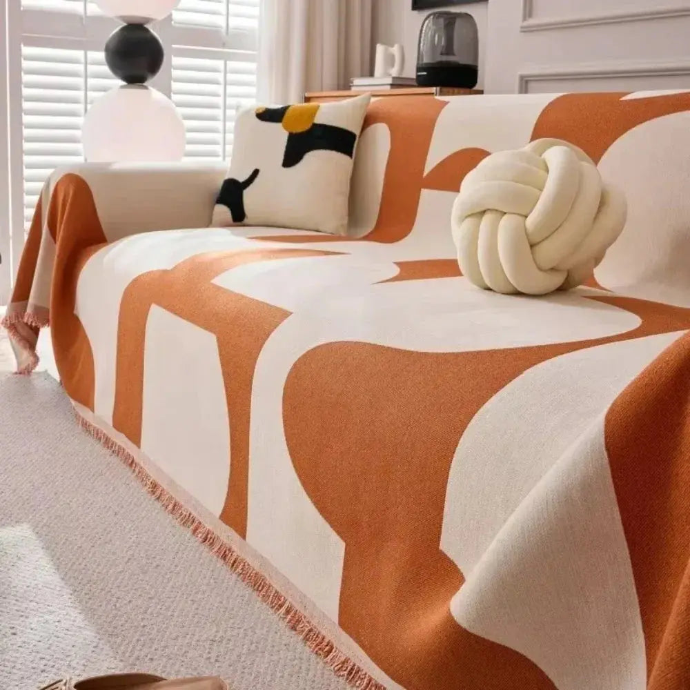 Orange and cream geometric couch cover on sofa