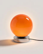 Orange glass globe table lamp