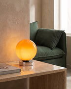 Orange globe lamp on coffee table