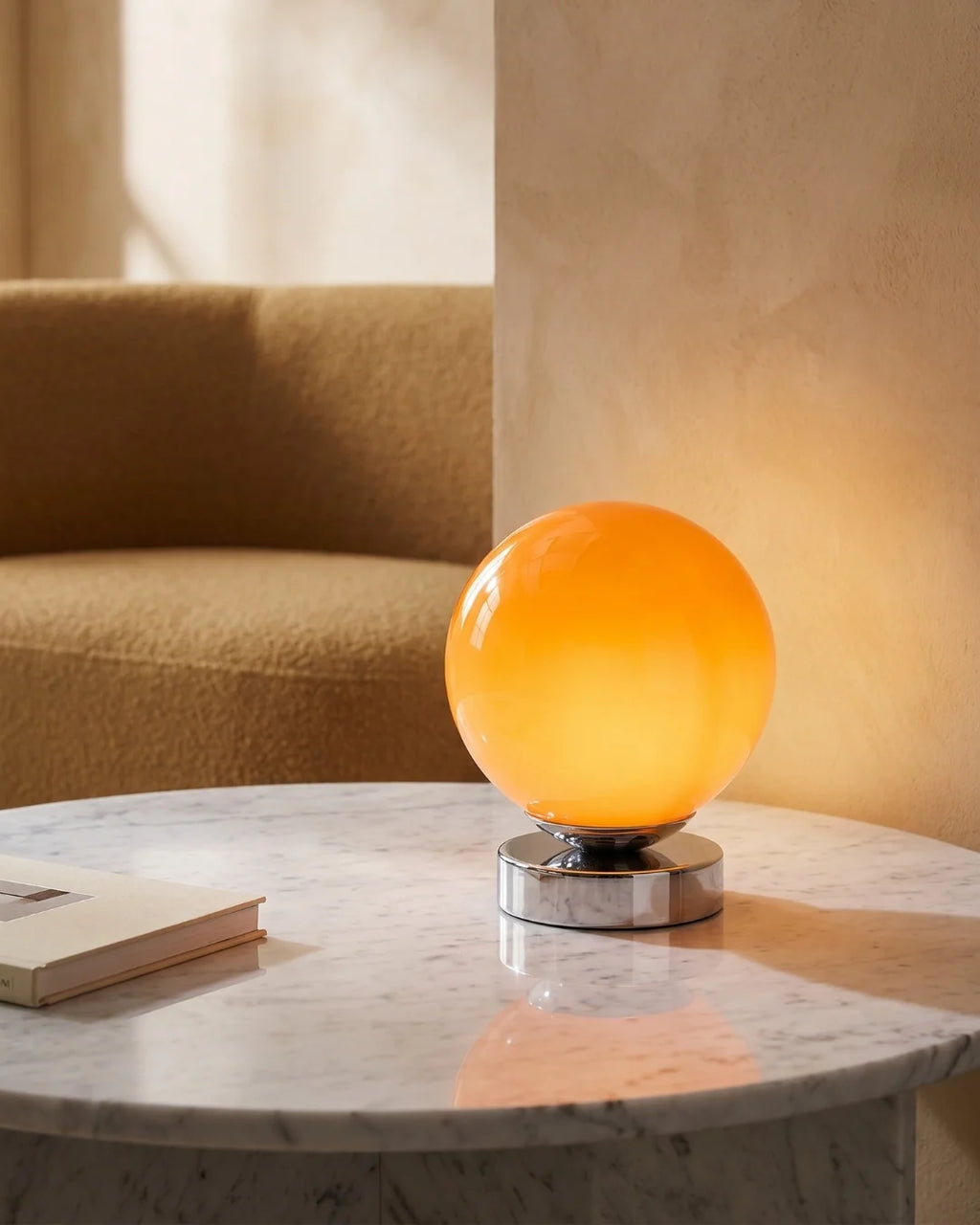 Orange globe lamp on marble table