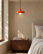 Orange pendant light in bedroom