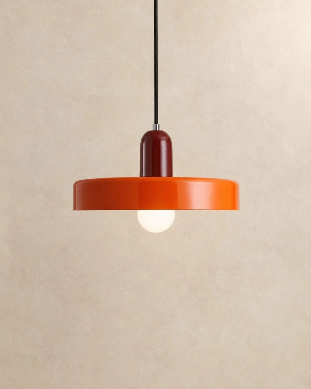 Orange pendant light with burgundy holder