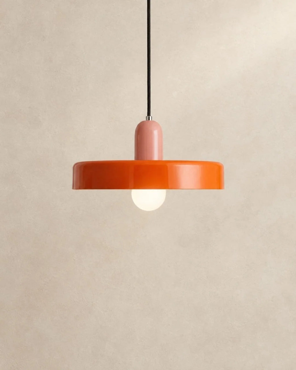 Orange pendant light with pink holder