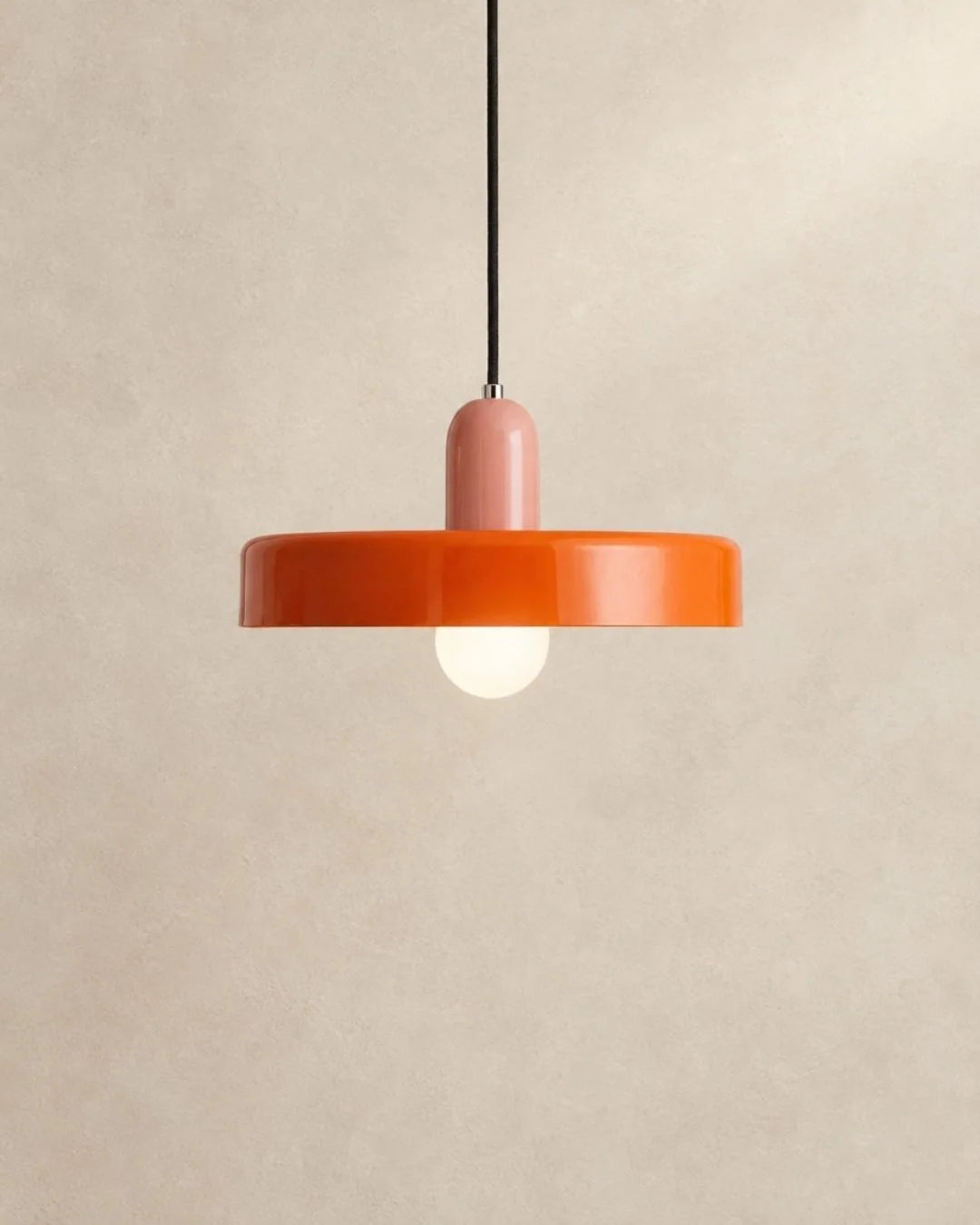 Orange pendant light with pink holder