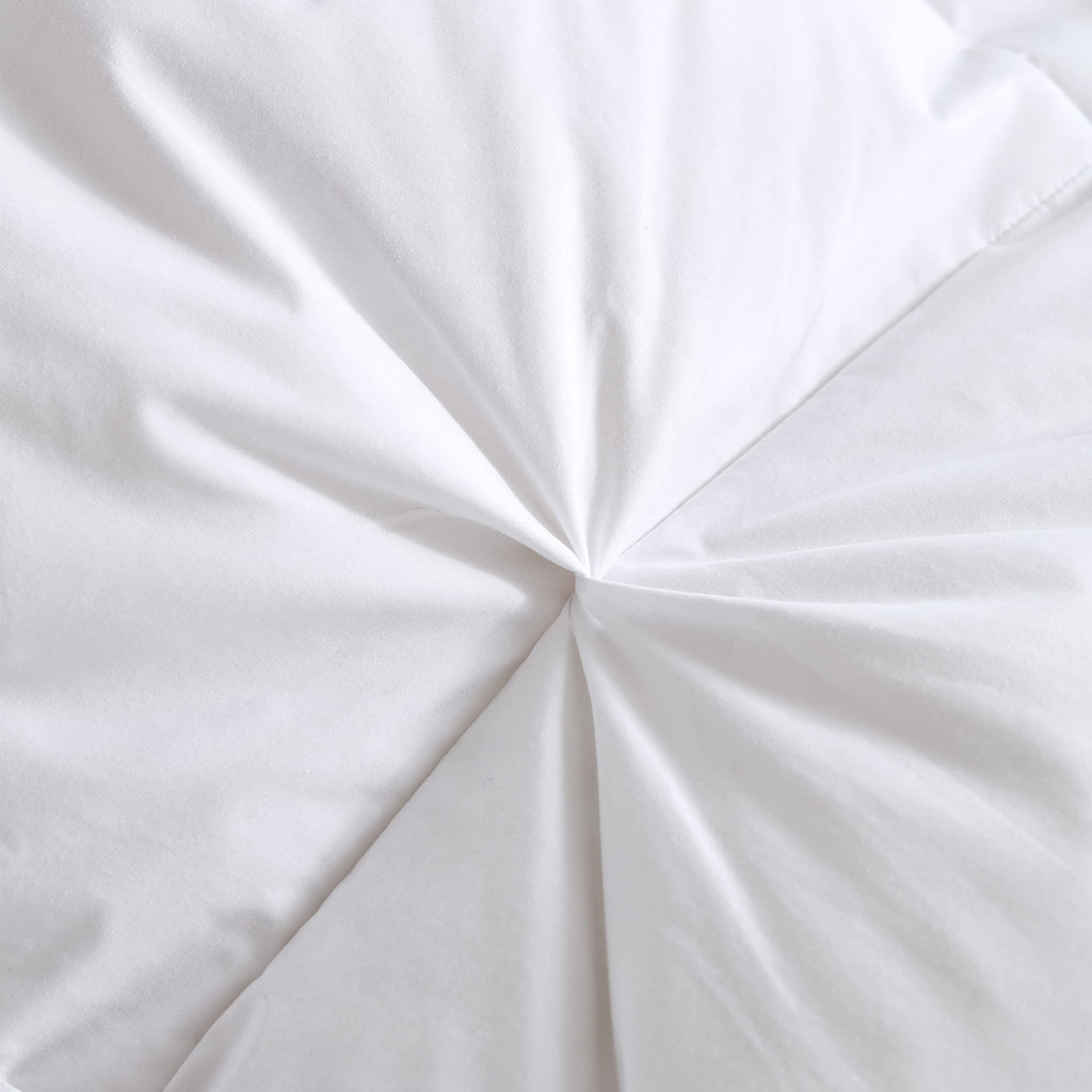 Pinch pleat detail on white comforter