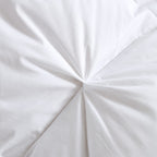 Pinch pleat detail on white comforter
