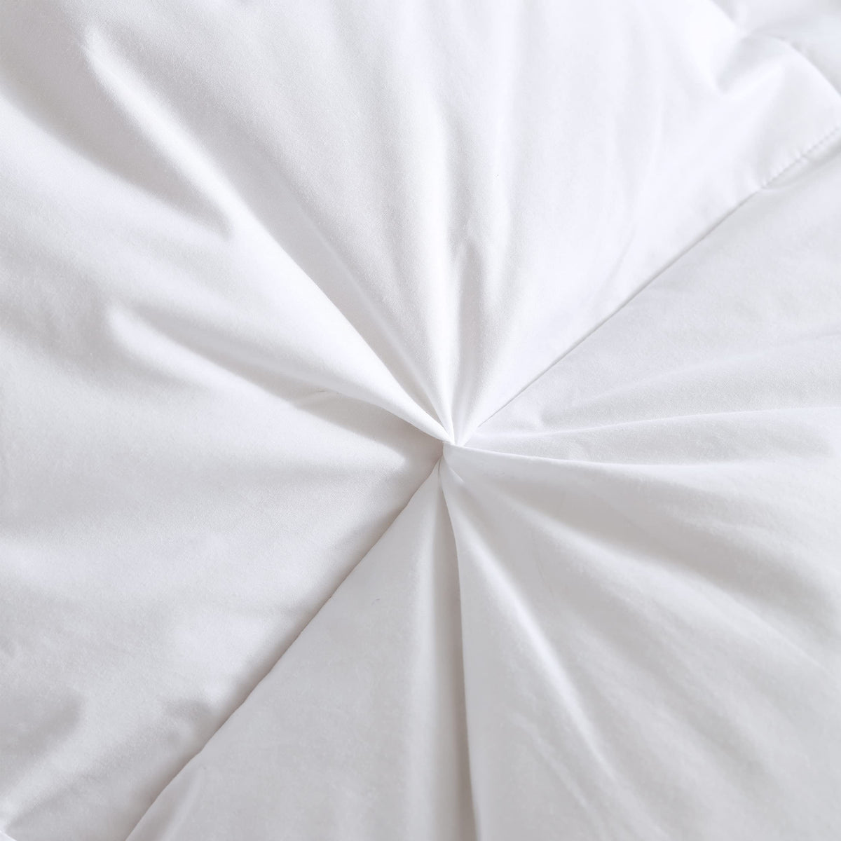 Pinch pleat detail on white comforter