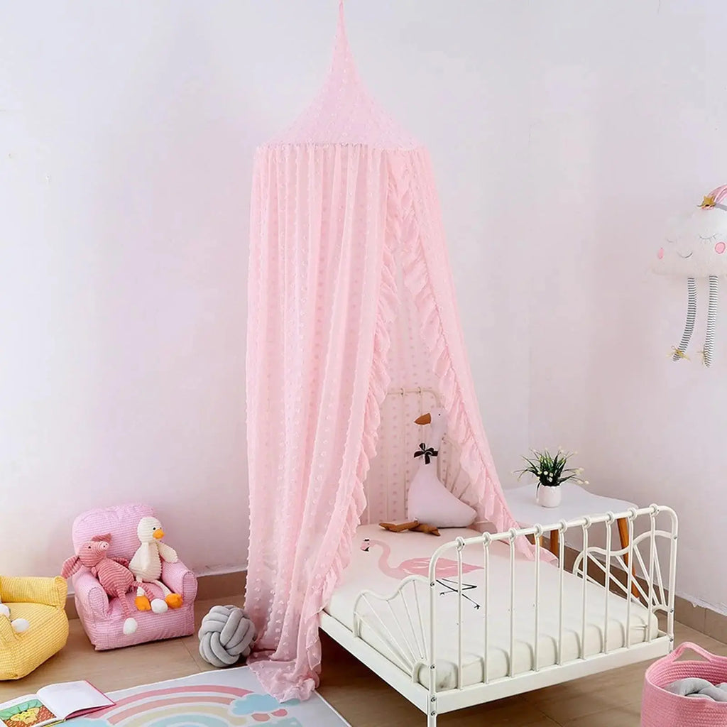 Pink canopy over toddler bed