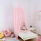 Pink canopy over toddler bed