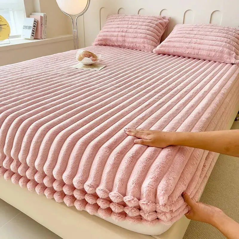 Pink faux fur fitted sheet on bed
