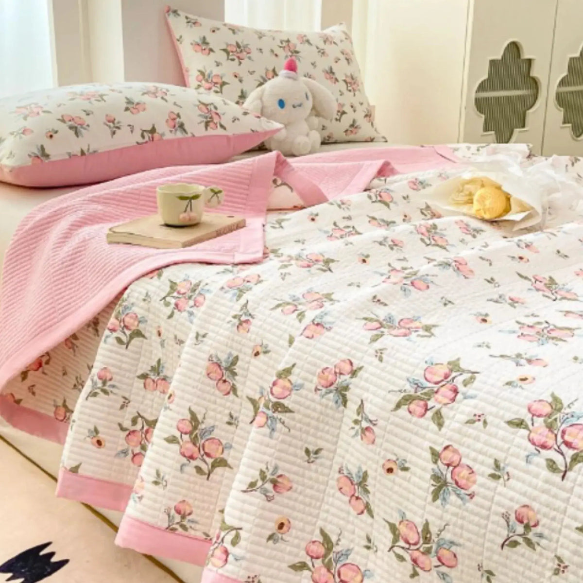 Pink floral bedding set on bed