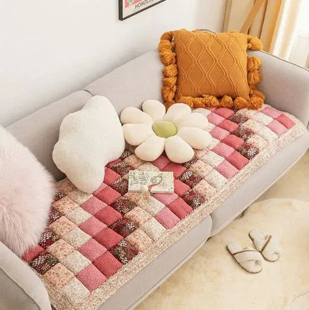 Pink floral quilted pet couch cover on sofa