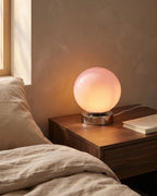 Pink globe lamp on nightstand