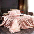 Pink satin bedding set on bed