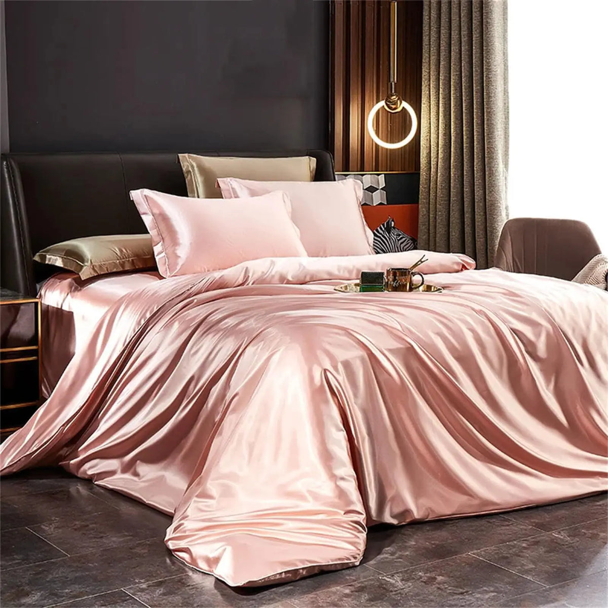 Pink satin bedding set on bed