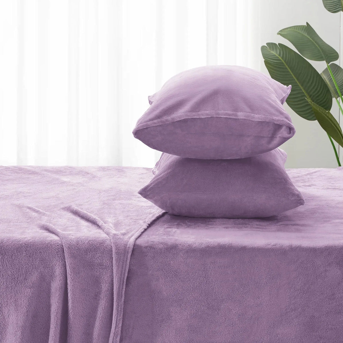 Purple fleece pillowcases on fitted sheet