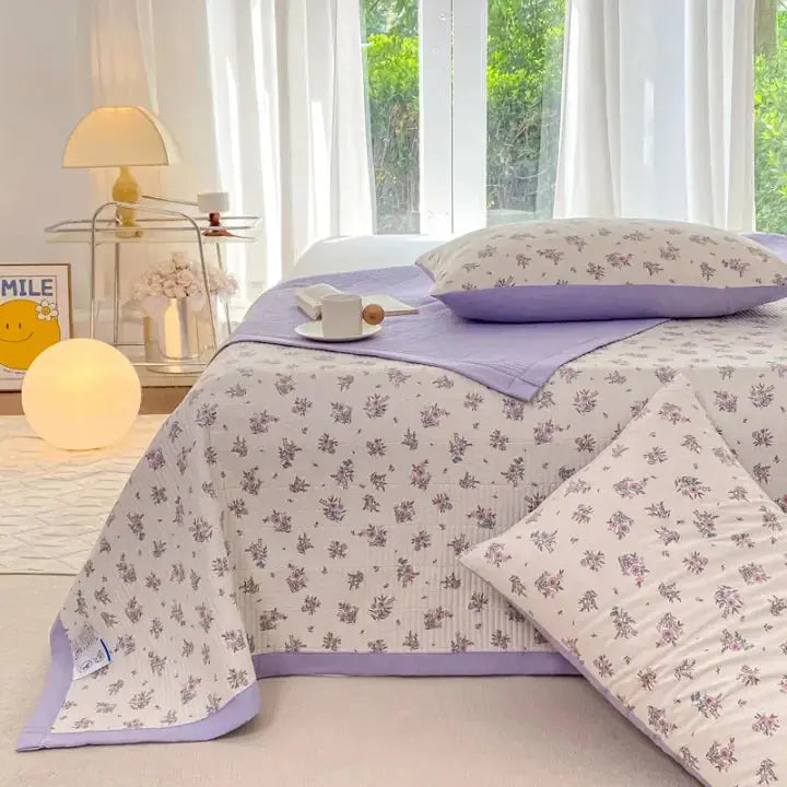 Purple floral bedding in bright bedroom