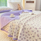 Purple floral bedding set on bed