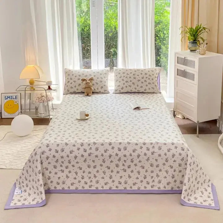 Purple floral bedding set on queen bed