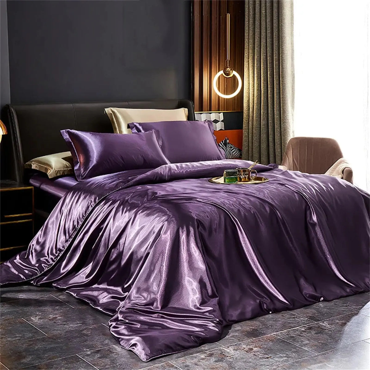 Purple satin bedding set on bed