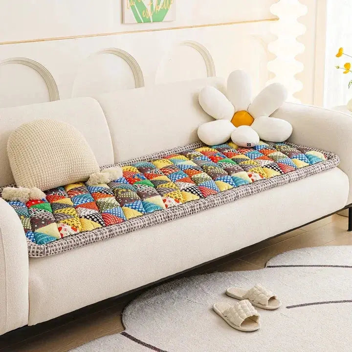 Quilted patchwork couch cover on white sofa